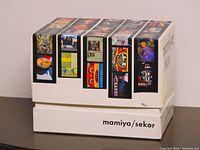 Original colorful Mamiya Sekor camera box with assorted photo images on sides, showing branding and packaging style.