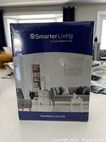 Front view of Smarter Living furniture care kit in original sealed packaging.