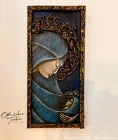Full view of the Madonna and Child wall art in blue and gold tones with ornate frame.