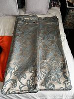 Full view of both folded window panels lying on a couch/table showing color and pattern.