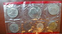 Photo showing all six coins sealed in mint cellophane packaging. Coins arranged in two rows of three.