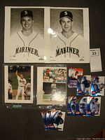 Two 8x10 black and white portraits of Seattle Mariners players Tino Martinez and Bret Boone plus color photos and set of seven Upper Deck Pepsi collectible Mariners cards.