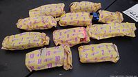 Top view of wrapped Hot Wheels Revealers contest cars, numbered 1-10 in original yellow water-dissolvable envelopes with purple numbering and branding.