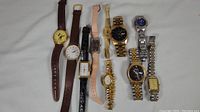 Full collection of 9 vintage wristwatches showing a variety of dial shapes, band materials, and colors including the Loris Mickey Mouse watch