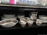 Top and bottom shelves showing bowls, cups, serving bowl and plates