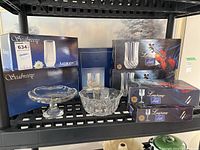 Photo showing boxed Luminarc Seabreeze glassware and boxed Longchamp stemware sets along with two crystal pedestal bowls.