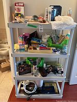Four shelves of assorted health and beauty products including cervical collar box, toothbrushes, feminine products, heating pad, small medical supplies, and a Philips shaver.