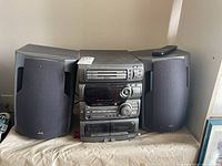 Front view of the JVC stereo system showing dual cassette decks and speakers