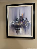 Photo showing the oil painting on canvas of the Toronto skyline with CN Tower, framed in a black and cream frame, mounted on a wall.