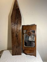 Arrow shaped cedar wood hanging rack and wooden framed craftsman mirror on table against wall