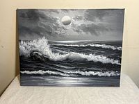 Full view of black and white oil painting depicting ocean waves under a cloudy sky with a moon and birds.