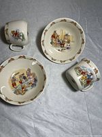 Set of 2 cups and 2 bowls with Bunnykins illustrations on gray surface