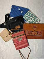 Overview of all six small purses showing variety of colors, materials and styles.