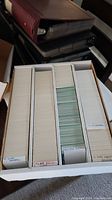 Box with 4 rows of baseball cards sorted and labeled, showing full collection in organized white box.