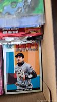 Photo of box showing Jordan Lawlar baseball card and various packs and singles inside box