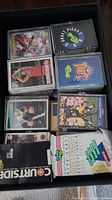 Box of assorted sports cards including loose cards in protective sleeves and unopened card packs/boxes