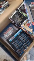 Open box containing multiple opened sports card packs including Bowman Chrome, Topps, Classic, and others.