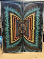 Full view of framed psychedelic butterfly velvet poster with concentric colorful geometric shapes.