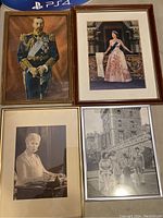 Four framed pictures arranged with two portraits in color and two black and white photographs showing British royals.