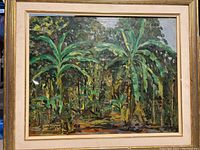 Front view of the framed oil painting on board showing dense tropical foliage and trees.