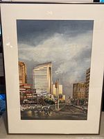 Framed watercolor painting showing full composition of urban street scene