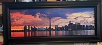 Front view of the framed panoramic Toronto skyline picture at sunset.