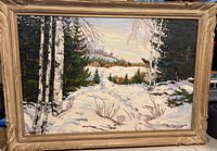 Full front view of the framed oil painting showing the snowy winter landscape with trees and mountains.