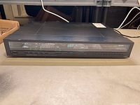 Front view of the Onkyo Integra T-9060 tuner showing the front panel display and buttons.