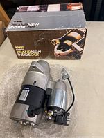 Front view of TYC starter motor on bubble wrap with original branded box behind.