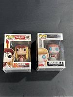Front view of two Funko Pop figures in boxes; Carrie #467 and Annabelle #469.
