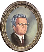 Oval oil portrait painting on board of a man in brown suit and glasses, signed by Deece Doram dated 1974, framed with cracked ornate gold-tone frame.