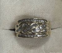 Front/top view showing two rows of round diamonds and central wave of baguette diamonds