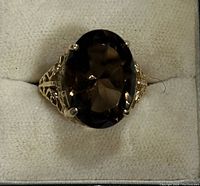 Top view of ring showing oval faceted smoky quartz and prong setting