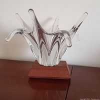 Front view of clear crystal splash sculpture on wood base