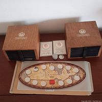 Overview of Canadian coin set, two wooden Olympic sponsor boxes, two Nixon medals