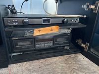 Onkyo dual cassette deck and Panamax power manager inside a cabinet, showing front view of both units.