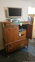Full front view of assembled armoire dresser, TV on top not included