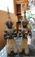 Front view of both kneeling brass goddess statuettes on countertop