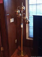 Full frontal view of the lamp showing all five chrome ball shades and base