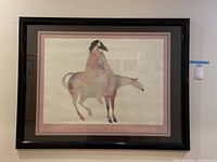 Frontal view of the framed wall art poster showing the entire artwork with a figure on a horse, framed in black.