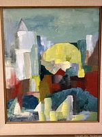 Close-up view of abstract painting showing geometric shapes and color details