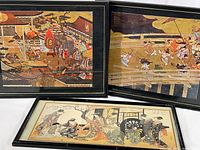 Three framed Japanese prints: two in matching black wooden frames, one in faux bamboo black frame.