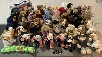 Full collection of approximately 43 TY Beanie Babies arranged in rows, showing variety of colors and styles, mostly with heart tags visible.