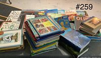 Photo showing stacks and spread of children's books of various titles on a table