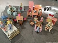Photo showing entire set of doll furniture and dolls arranged on floor.