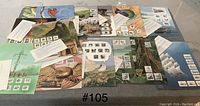 Four large illustrated display boards laid out showing multiple international stamps attached, varied thematic artwork backgrounds