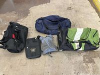 Group photo showing all five duffle bags arranged on floor showcasing size, color, and condition.
