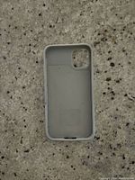 Photo showing inside of the iPhone 11 battery case with soft matte grey lining and camera cutout.