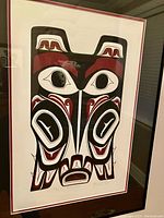 Framed print of Native Northwest Coast-style Raven Totem by Clarence Mills in black, red, and white.