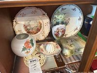 Kaiser vase, Japanese juicer, Nippon trinket box, unmarked vase, and Wedgwood plates displayed together